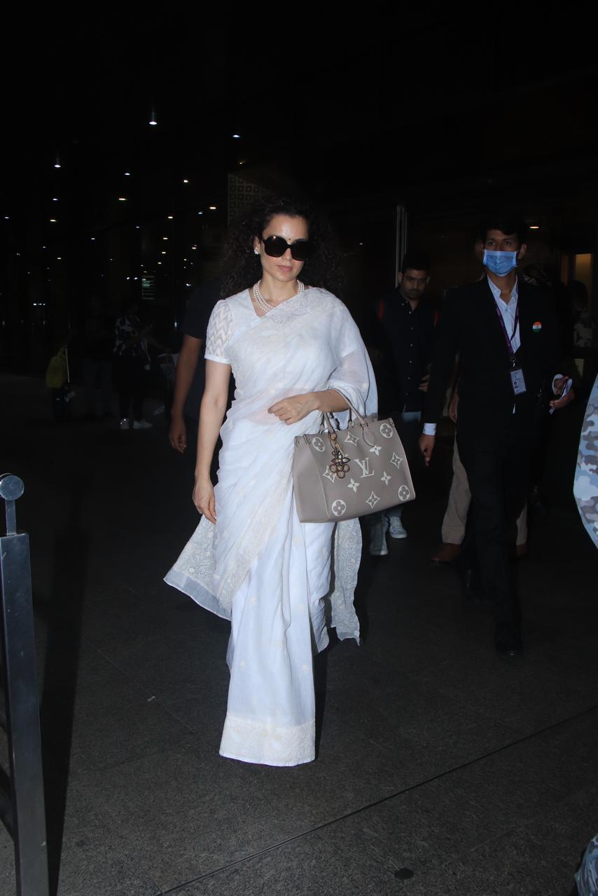 Kangana Ranaut made a stylish statement as she was spotted at the airport, donning an elegant white saree. Her graceful presence and impeccable fashion sense turned heads and showcased her unique sense of style, making her airport look a true reflection of her fashion-forward persona.